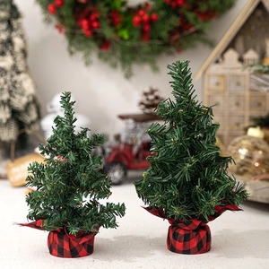 Mini green Christmas trees set with red plaid fabric base for holiday tabletop decor
