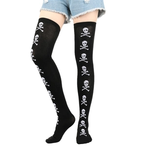 Close-up of black over-the-knee socks with white skull and crossbones pattern