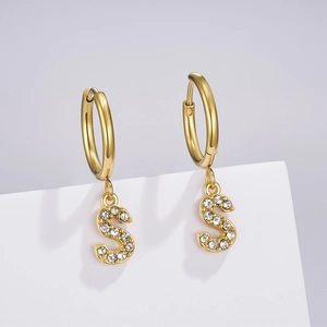 Detail view of gold stainless steel hoop earring with a sparkling zircon letter S pendant