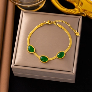 Elegant gold snake chain bracelet featuring emerald green gemstones and heart charm