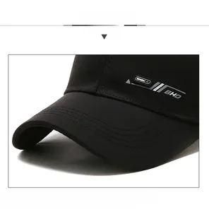 Detail view of reinforced brim with precision stitching on a black cotton baseball cap
