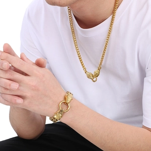 Detail of gold-plated stainless steel snake head clasp on woven dragon chain necklace