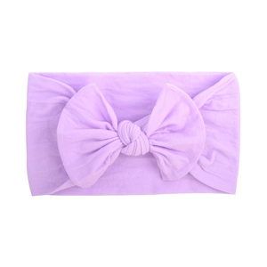 Close-up of light purple baby headband with a large soft fabric bow on white background