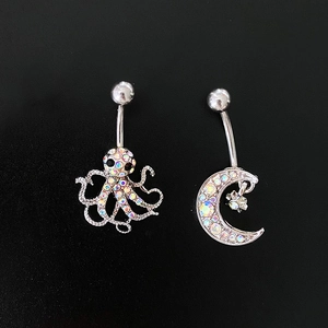 Star moon and octopus navel rings with colorful zircons on black background