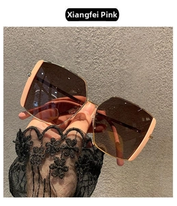 Detail of nude pink oversized square sunglasses with gradient lenses and faceted edges