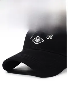 Close-up of white WangeroYe embroidery on a black cotton twill baseball cap with curved brim