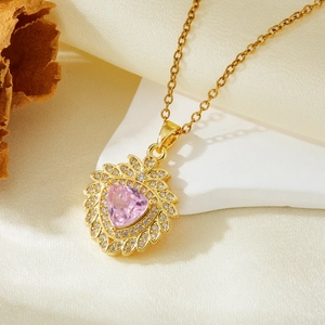 Detail of pink triangle zircon pendant with sparkling white crystals on gold chain