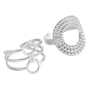 Macro detail of geometric silver rings with three-layer band and textured oval design