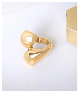 Detailed shot of unique organic shaped ring in polished 18K gold plated titanium steel