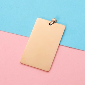 Close-up of polished rose gold rectangular pendant tag for DIY jewelry and engraving