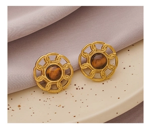 Detailed macro view of vintage gold round stud earrings with tiger eye stone inlay