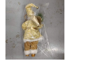 Close-up of standing Santa Claus doll in gold patterned robe with white plush trim
