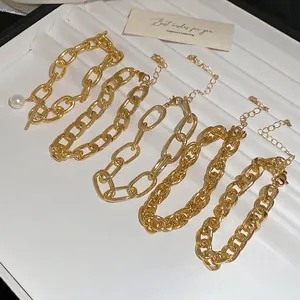 Five-piece gold metal chain bracelet set featuring curb and paperclip link designs