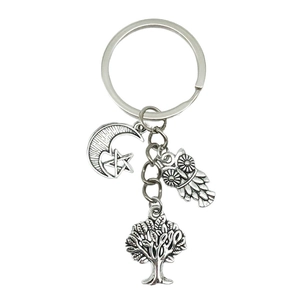 Antique silver tree of life keychain with moon star and owl charms on white background