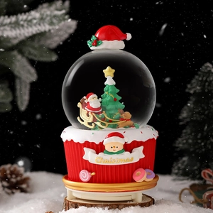 Luminous Christmas snow globe with Santa and reindeer on a festive cupcake base
