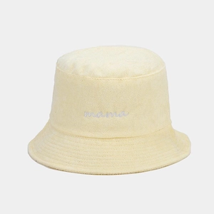 Close-up of yellow mama embroidery on soft terry cloth bucket hat with fuzzy texture