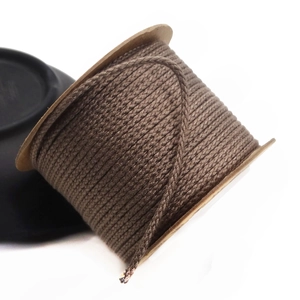 Detail of 1.5mm brown braided cotton cord neatly wound on a kraft paper spool