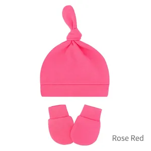 Detail of rose red knitted newborn baby knot hat and matching anti-scratch mittens set