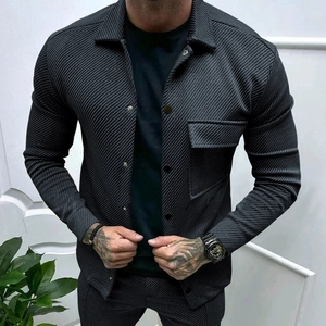Detail of dark grey slim-fit twill jacket featuring fine vertical textures and chest pocket