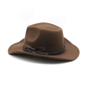Detail of brown felt western cowboy hat featuring ribbon band and gold metal accents