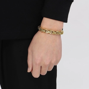 Detail of 8mm 18K gold plated titanium steel king chain bracelet on a male wrist