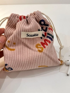 Pink corduroy drawstring storage bag with smile pattern and colorful letter print