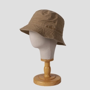 Khaki cotton bucket hat with Urban Aurora embroidery on light gray mannequin stand