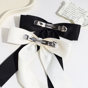 Minimalist black and cream satin bow hair clips with silver spring metal fasteners