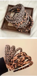 Detailed view of handmade leopard print headband with soft fabric and inner engraving