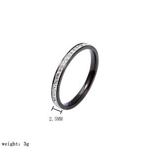 Macro view of 2.5mm black stainless steel ring with single row of clear crystals.