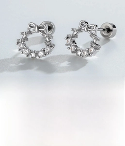 Detail of silver bow wreath cartilage stud earring with micro-pave cubic zirconia