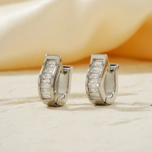 U-shaped silver-plated hoop earrings with rectangular zircon stones on textured surface