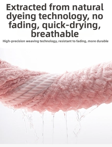 Close-up of pink microfiber towel being wrung out showing high water absorption and fast drying