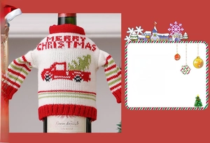 Close-up of knitted Christmas wine bottle cover with red truck and festive tree motif