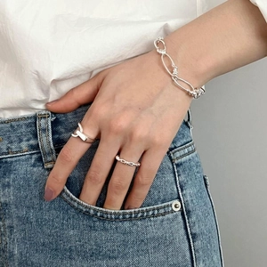 Set of 925 sterling silver minimalist rings and chain bracelet shown on a hand
