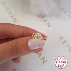 Detailed close-up of a 925 sterling silver gold-plated ring with sunburst design