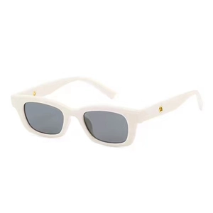 Detail view of white vintage small frame sunglasses with gold temple accents and dark lenses