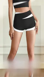 Detail of high waisted yoga shorts featuring black and white contrast and crossover design
