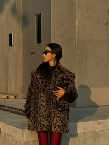 Street style shot of a midi leopard print faux fur coat with silhouette design
