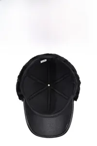 Close-up of winter leather aviator hat with thick black faux fur lining and ear flaps