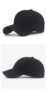 Close-up of black baseball cap with 3D embroidered letter D on twill fabric