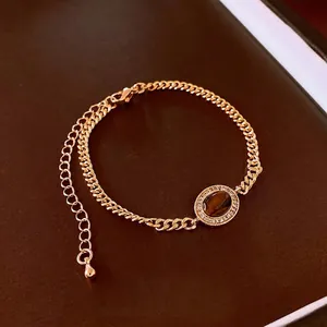 Gold plated bracelet featuring an oval tiger eye stone with sparkling zircon accents
