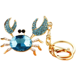 Blue crystal crab keychain with rhinestones and gold-plated finish on white background