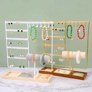 Modern metal jewelry stand with wooden base tray for earrings and rings in gold and white