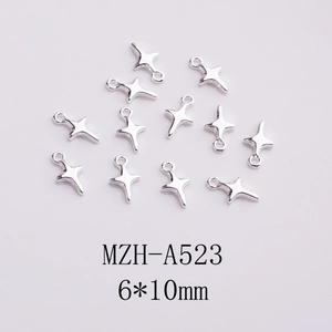 Detail view of 6x10mm silver four-pointed star alloy charms for DIY nail art and jewelry