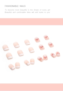 Detail of short pink gradient false nails with cherry blossom art and silver French tips