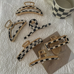 Checkboard hair claws set in black and white with gold trim for various hairstyles