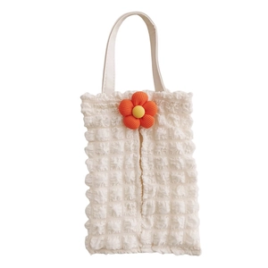 Detail of cream bubble fabric car tissue box cover with a 3D orange flower decoration
