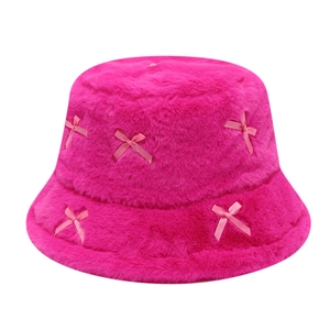 Fuzzy pink bucket hat with ribbon bows and soft plush texture on white background