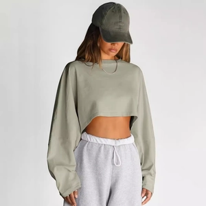 Sudadera corta de manga larga verde oliva para mujer con pantalones deportivos grises y gorra